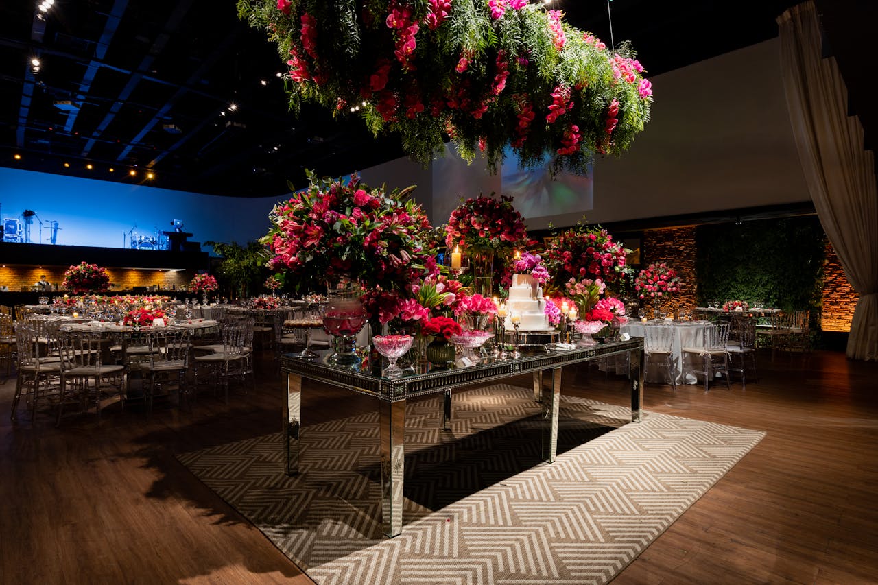 why-choose-us-img A beautifully decorated wedding venue with vibrant floral arrangements and elegant table settings under romantic lighting.